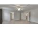 Large bedroom with neutral paint, ceiling fan, and open door to ensuite at 7013 Early Gold Ln, Riverview, FL 33578
