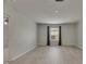 Light-filled bedroom features wood-look floors and a window with gray drapes at 7013 Early Gold Ln, Riverview, FL 33578