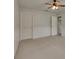 Spacious bedroom with wainscoting, carpet, and an open closet at 7013 Early Gold Ln, Riverview, FL 33578