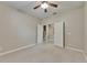 Carpeted bedroom with open doors and neutral walls at 7013 Early Gold Ln, Riverview, FL 33578