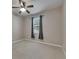 Neutral bedroom featuring carpet, ceiling fan, and a window with gray drapes at 7013 Early Gold Ln, Riverview, FL 33578