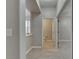 Bright hallway features wood-look floors and leads to a bathroom and carpeted bedrooms at 7013 Early Gold Ln, Riverview, FL 33578