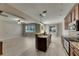 An open concept kitchen with stainless steel appliances and a breakfast bar that opens to the living room at 7013 Early Gold Ln, Riverview, FL 33578
