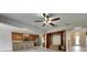 Open concept kitchen and living room offers stainless appliances, wood cabinets, and wood-look floors for a warm feel at 7013 Early Gold Ln, Riverview, FL 33578