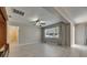 Open concept living room provides an abundance of natural light through a large window and patio doors at 7013 Early Gold Ln, Riverview, FL 33578