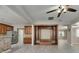 Open concept kitchen and living space is perfect for entertaining with wood cabinets, tile backsplash, and stainless appliances at 7013 Early Gold Ln, Riverview, FL 33578