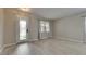 Living room with luxury vinyl plank flooring, neutral paint, and plenty of natural light at 7013 Early Gold Ln, Riverview, FL 33578