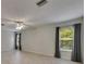 Bright living room featuring wood-look floors and a ceiling fan at 7013 Early Gold Ln, Riverview, FL 33578