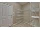 A pantry with wire shelving on all walls and a white door to the outside at 7013 Early Gold Ln, Riverview, FL 33578