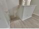 Stairway landing features wood-look floors and a white banister at 7013 Early Gold Ln, Riverview, FL 33578