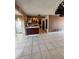 Living room with a view of the kitchen, tile floors and a sliding glass door at 7021 Mayfield Dr, Port Richey, FL 34668