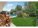 Lush backyard featuring a refreshing pool and a charming gazebo, creating an ideal outdoor retreat at 71 Flamingo Cir, Safety Harbor, FL 34695