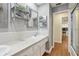 This bathroom features a double vanity, a shower, and a decorative mirror on the wall at 71 Flamingo Cir, Safety Harbor, FL 34695