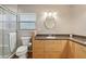 Bright bathroom featuring a vanity, a sink, a mirror, and a glass enclosed shower at 71 Flamingo Cir, Safety Harbor, FL 34695