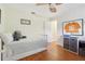 Cozy bedroom with white wood floors, a ceiling fan, and closet space at 71 Flamingo Cir, Safety Harbor, FL 34695