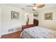 Cozy bedroom featuring hardwood floors, a ceiling fan, and a mounted television for comfortable living at 71 Flamingo Cir, Safety Harbor, FL 34695
