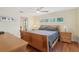 Bedroom with a wood bed frame, wood floors, a ceiling fan, and access to the bathroom and bonus room at 71 Flamingo Cir, Safety Harbor, FL 34695