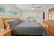 Spacious bedroom featuring a wood bed frame, wood floors, a ceiling fan, and a sunroom area at 71 Flamingo Cir, Safety Harbor, FL 34695