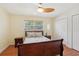 Bright bedroom with a ceiling fan, wood floors, and closet space at 71 Flamingo Cir, Safety Harbor, FL 34695