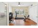 Bonus Room with office and exercise equipment, a ceiling fan, and wood floors at 71 Flamingo Cir, Safety Harbor, FL 34695