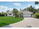 Charming single-story home featuring a well-manicured lawn, a two-car garage and beautiful curb appeal at 71 Flamingo Cir, Safety Harbor, FL 34695
