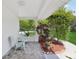 Comfortable side porch with chairs and decorative landscaping, offering a relaxing outdoor retreat at 71 Flamingo Cir, Safety Harbor, FL 34695