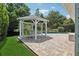 Beautiful gazebo with outdoor seating near a pool, creating an inviting space for entertaining and relaxation at 71 Flamingo Cir, Safety Harbor, FL 34695
