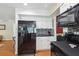 Sleek kitchen featuring black appliances, white cabinets, and a modern backsplash design at 71 Flamingo Cir, Safety Harbor, FL 34695