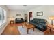 Comfortable living room with hardwood floors, a cozy rug, and a glimpse of the entry at 71 Flamingo Cir, Safety Harbor, FL 34695
