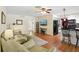Bright living room with wood floors, comfortable seating, and a view into the updated kitchen at 71 Flamingo Cir, Safety Harbor, FL 34695