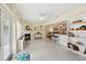 Bright living room with a fireplace, white floors, and access to an open kitchen with bar seating at 71 Flamingo Cir, Safety Harbor, FL 34695