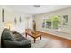 Inviting living room featuring hardwood floors, plantation shutters, and a glimpse of the front door at 71 Flamingo Cir, Safety Harbor, FL 34695