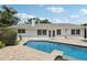 Relax by the beautiful pool, set against the backdrop of the home's exterior and lush landscaping at 71 Flamingo Cir, Safety Harbor, FL 34695