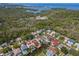 Beautiful aerial view of a waterfront home with lush landscaping and serene water views; ideal location at 77 Gulfwinds Dr, Palm Harbor, FL 34683