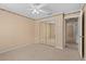 Bedroom features carpet floors, mirrored closet doors, and a neutral color scheme at 77 Gulfwinds Dr, Palm Harbor, FL 34683