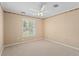 Bright bedroom with carpet, neutral paint, crown molding, and fan at 77 Gulfwinds Dr, Palm Harbor, FL 34683