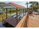 View of the boat lift and dock, with calm canal waters at 77 Gulfwinds Dr, Palm Harbor, FL 34683
