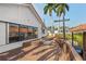 Exterior back of home with deck overlooking canal and boat lift at 77 Gulfwinds Dr, Palm Harbor, FL 34683