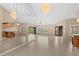 Bright living room with elegant chandeliers, tiled floors, and a mirrored wall at 77 Gulfwinds Dr, Palm Harbor, FL 34683