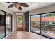 Bright sunroom with wood floors and glass sliders offering views of the deck and canal at 77 Gulfwinds Dr, Palm Harbor, FL 34683
