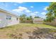 Back yard featuring a storage shed, grass, partial wood fence, and trees at 7991 54Th N St, Pinellas Park, FL 33781