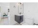 Bathroom with updated vanity, modern light fixture, toilet, and neutral paint scheme at 7991 54Th N St, Pinellas Park, FL 33781