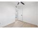 Neutral bedroom with white walls, wood-look floors, ceiling fan, and closet at 7991 54Th N St, Pinellas Park, FL 33781