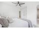 Bedroom featuring a plush bed with gray and white accents, modern ceiling fan, and ensuite bathroom at 7991 54Th N St, Pinellas Park, FL 33781