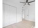 Bright bedroom features neutral paint, closet, ceiling fan, and wood-look flooring at 7991 54Th N St, Pinellas Park, FL 33781