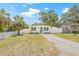 Well-maintained single-story home with a green front door, updated windows, and landscaping at 7991 54Th N St, Pinellas Park, FL 33781