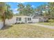 Charming single-story home featuring a freshly painted exterior, green door, new windows, complemented by well-maintained landscaping at 7991 54Th N St, Pinellas Park, FL 33781