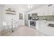 Contemporary kitchen with stainless steel appliances, white cabinetry, and an adjacent dining area at 7991 54Th N St, Pinellas Park, FL 33781