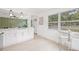 Kitchen view showing modern white cabinets, quartz counters, stainless steel appliances, and lots of natural light at 7991 54Th N St, Pinellas Park, FL 33781