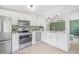 Bright kitchen features stainless steel appliances, white cabinetry, and a green backsplash at 7991 54Th N St, Pinellas Park, FL 33781